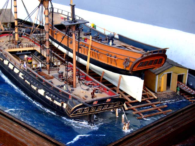 A fabulous and highly detailed scale model diorama circa 1920 of a New England Ship yard circa 1800-1812 making repairs on a 38 Gun American Frigate and a 10 Gun Privateer built circa 1785. — image 2